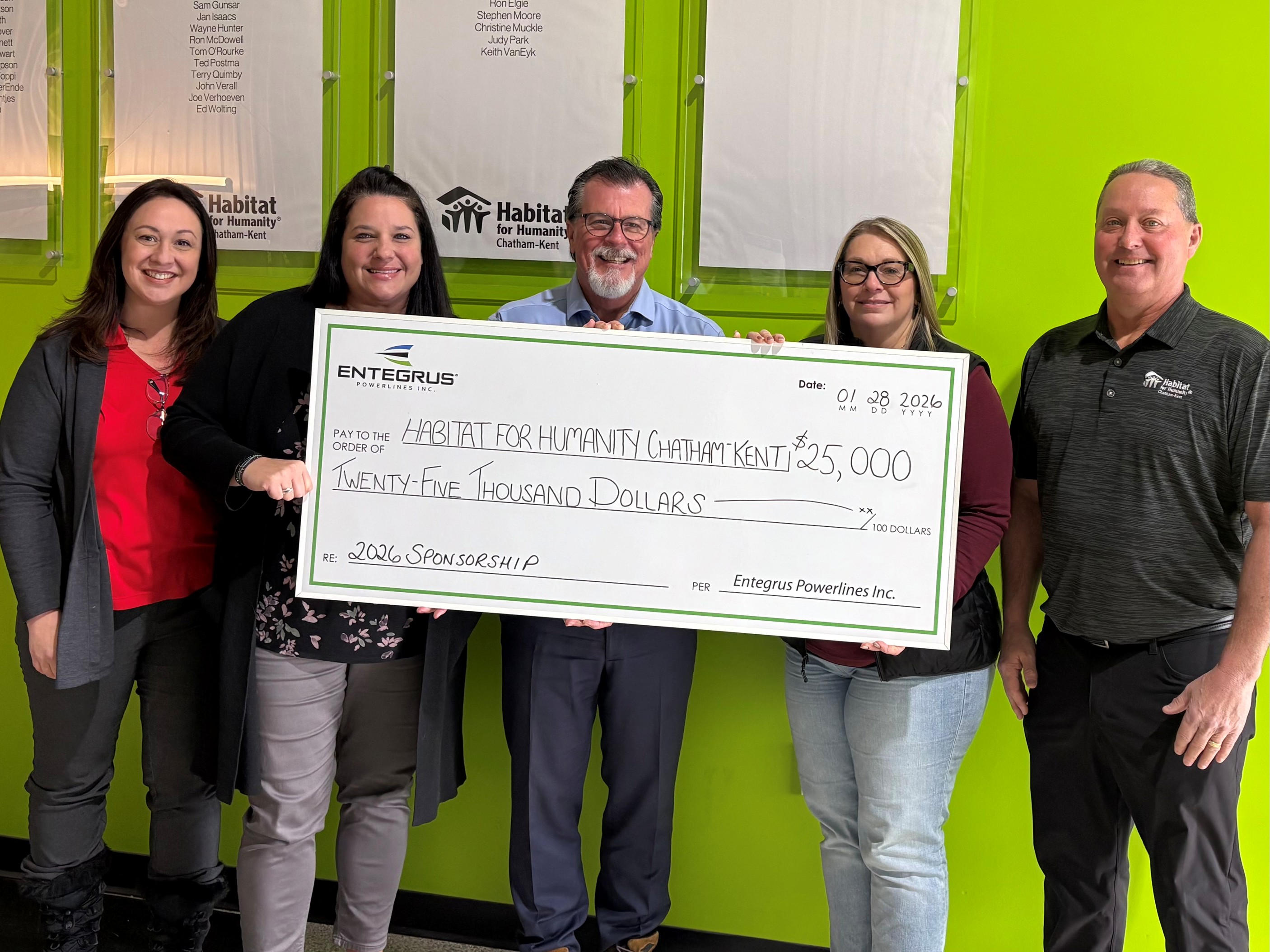 Group holding large cheque showing $25000 donation